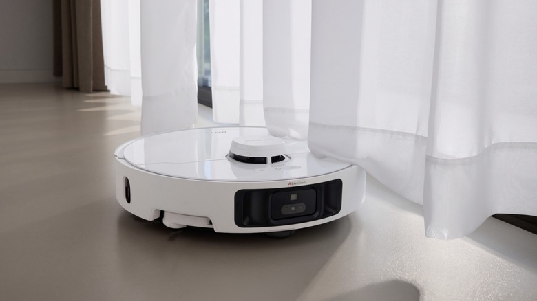 MOVA P10 Pro Ultra rolling underneath a white curtain