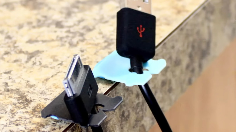 A pair of cables held in place by bread tags and putty.