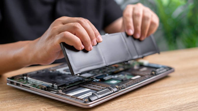 Man removing his laptop battery