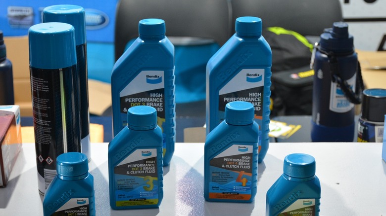 A picture depicting bottles of dot 3 and dot 4 brake fluid