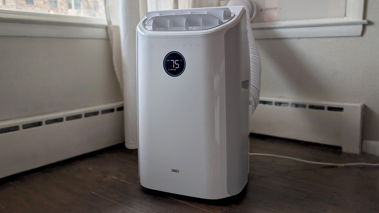 Dreo brand air conditioner on wood floor.