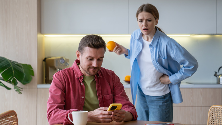 woman looking over man's shoulder