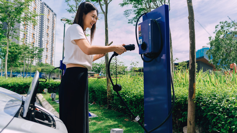 person plugging in ev