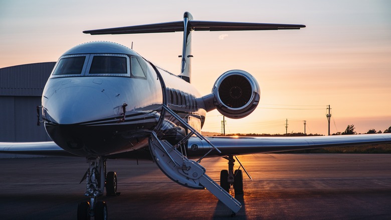 Jet parked at sunrise with boarding stairs down
