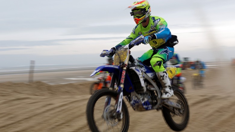 enduro biker jumping on sand dunes