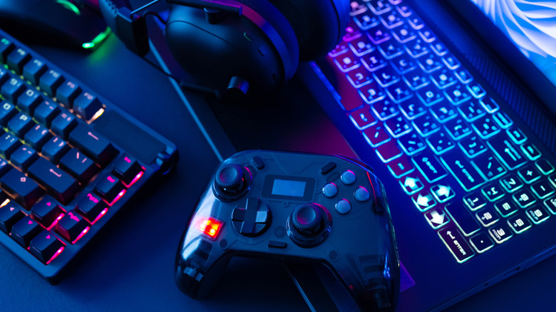 Video game controller and keyboard on a desk