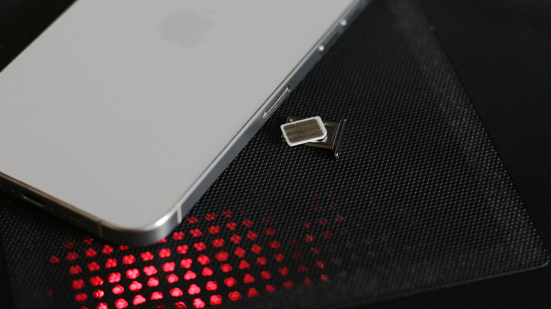 SIM card next to an iPhone