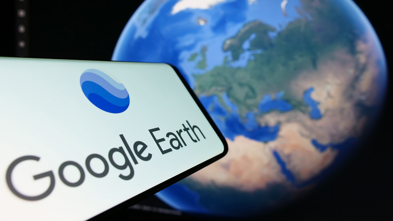 Google Earth icon opened on a phone above a rendering of the Google Earth map