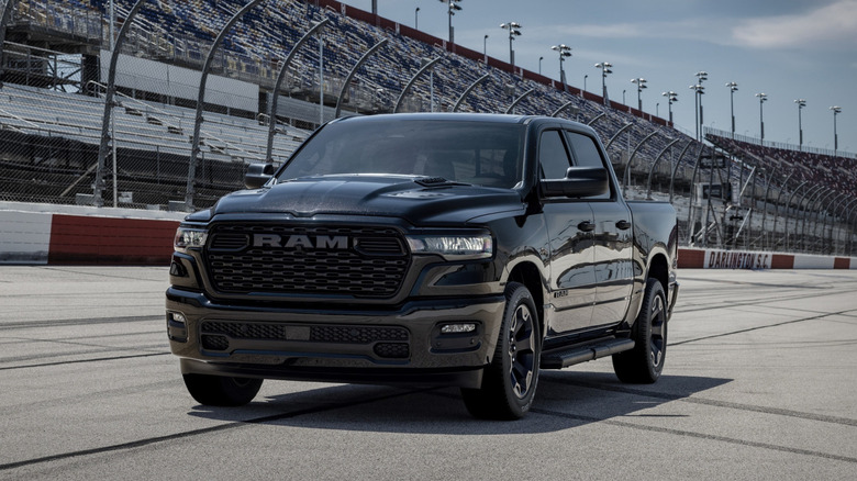 A black Ram 1500 parked on a track