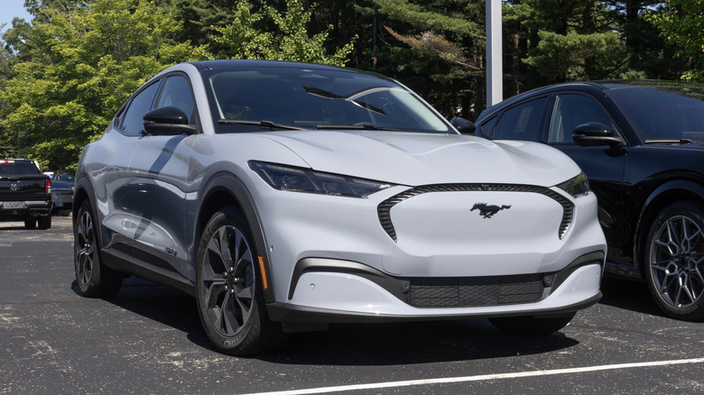 A white Ford Mustang EV in a parking lot