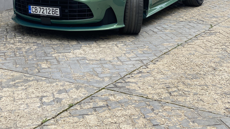 Green Aston Martin DB12 parked on a road
