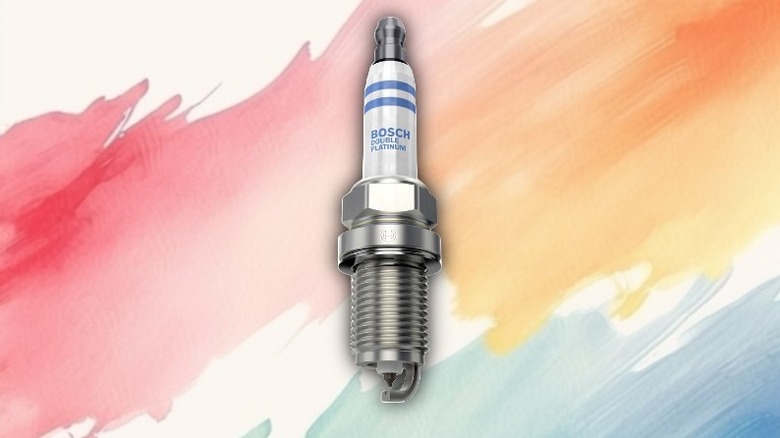 A double platinum spark plug on a painted background.