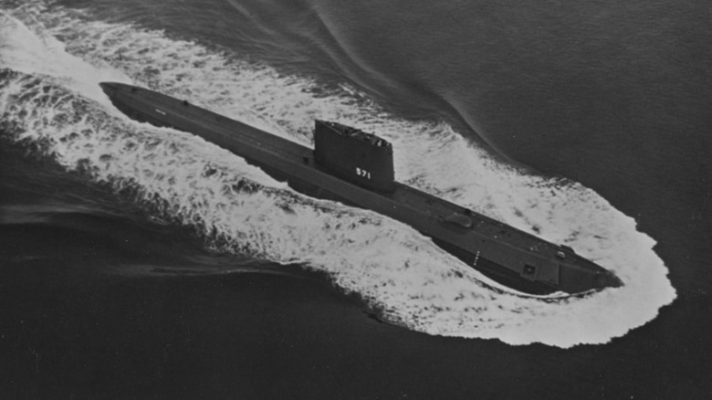 Black & white photo of USS Nautlius surfaced and sailing