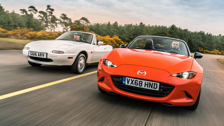 Front 3/4 views of Mazda Miata NA and Mazda Miata ND