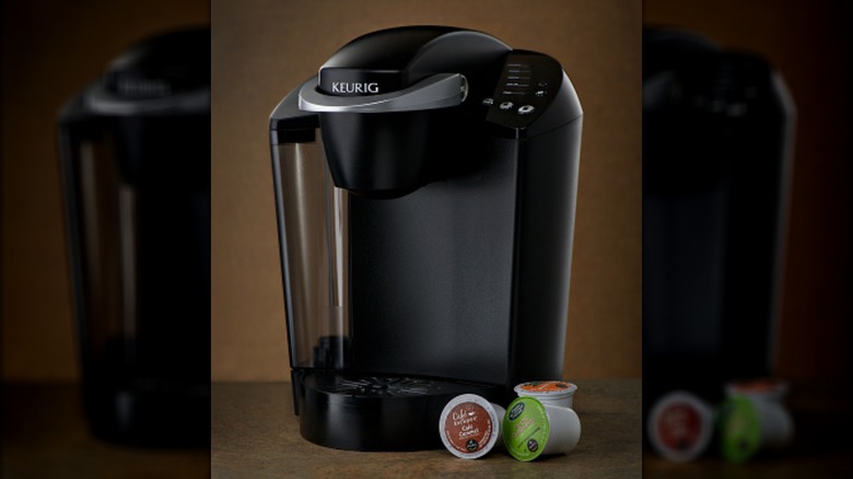 black Keurig coffee maker with pods on countertop