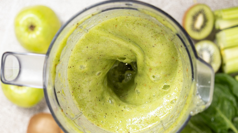 Blender making green smoothie