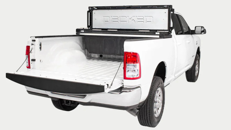 White pickup with open tailgate and open toolbox mounted in bed