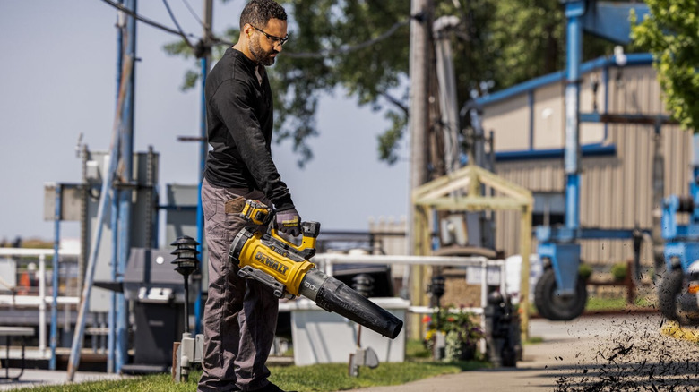 DeWalt DCBL777B blower blowing mulch from a path