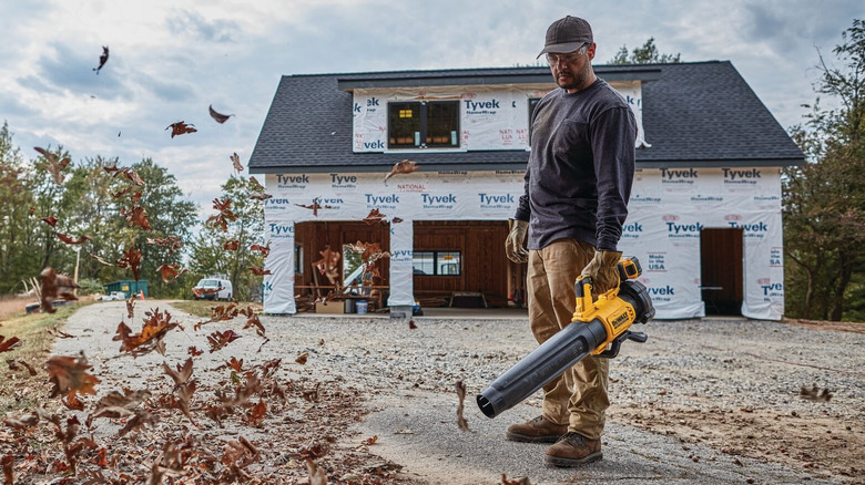DeWalt DCBL722B blower blowing leaves on a construction site
