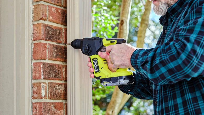 Man using Ryobi rotary hammer drill