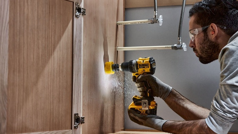 Person using DeWalt cordless drill