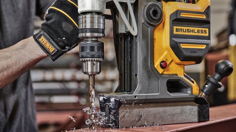 Person using DeWalt magnetic drill press
