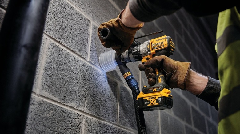 Person using DeWalt three-speed hammer drill