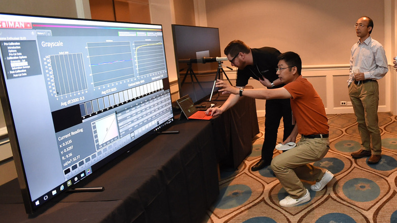 Samsung technicians showcase HDR10 on a large TV.