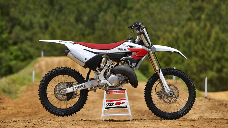 Red and White 70th Anniversary YZ 125 overlooking a course
