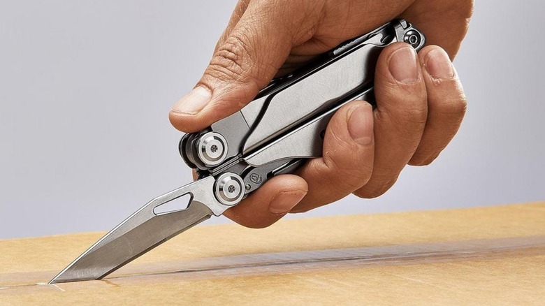 Person using Gordon Multi-tool to open a box