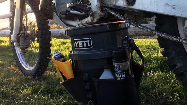 A Yeti 5-gallon bucket next to a motorcycle.