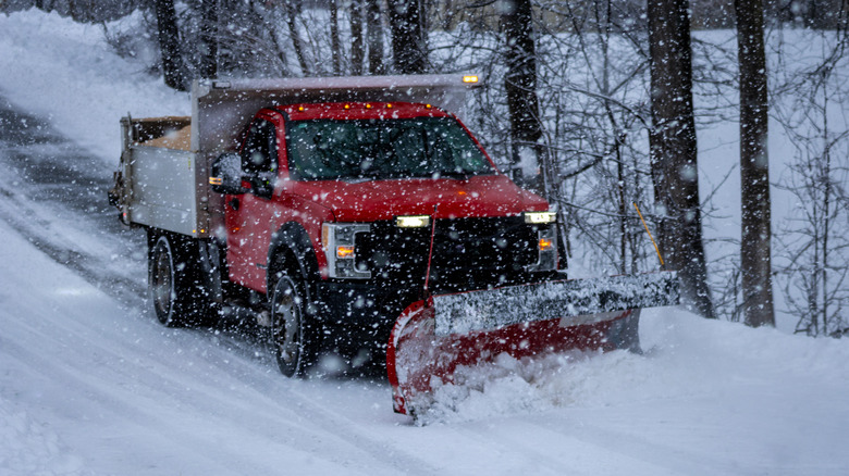 A snow plow clearing snow from a road.