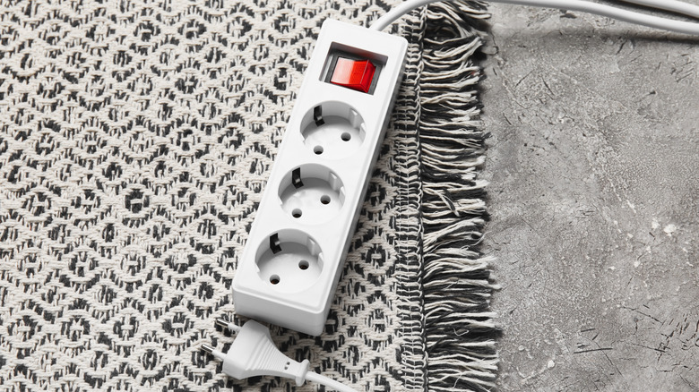 Extension cord resting on rug