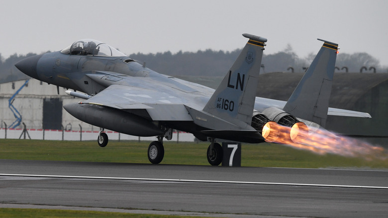 An F-15 Eagle performing aerobatics at an air show.