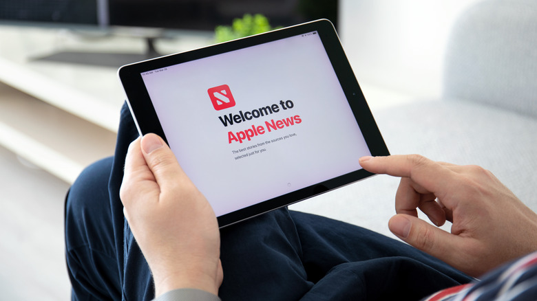 Someone using Apple news on Tablet