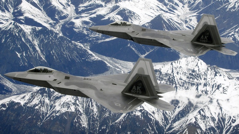 Two F-22 Raptors flying in formation in Alaskan airspace