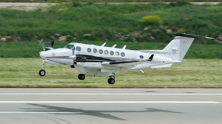 A small private plane landing on a runway