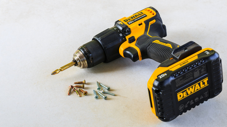 Dewalt Cordless Hammer Drill-Driver with screw on Cement board background