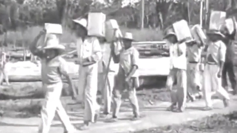 Archive Footage Of Fordlandia Indigenous Workers Moving Materials