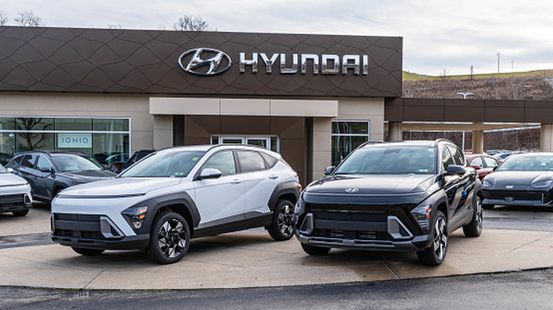 Two Hyundai SUVs parked in front of a Hyundai dealership