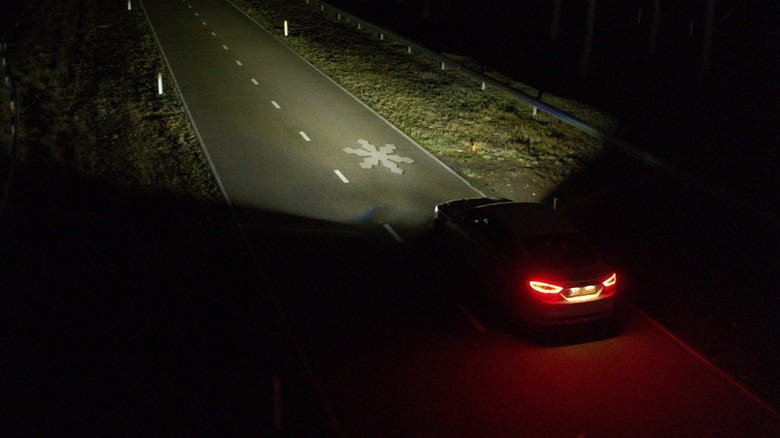 Ford car headlight projecting weather information.