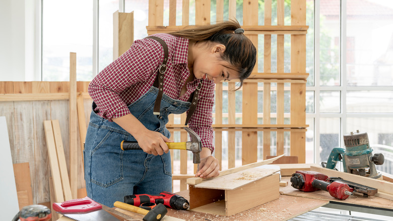 Person using hammer and nail