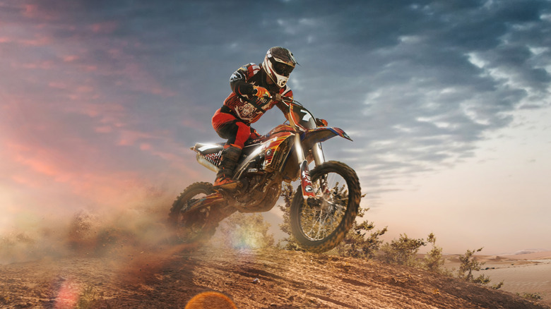 Dirt bike racer jumping sand dunes