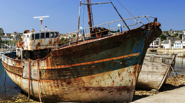 A dilapidated boat in a harbor