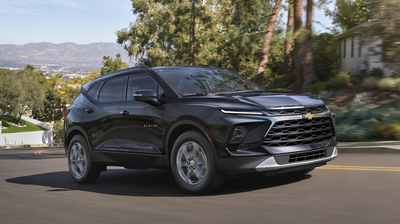 Black Chevrolet Blazer driving on a suburban street