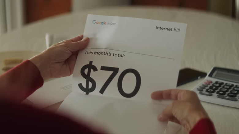 Hand holding Google Fiber internet bill