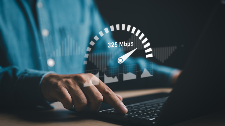 Digital rendering of a speedometer projected in front of person using laptop