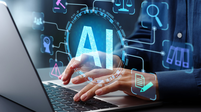 A person on a computer with an AI hologram.