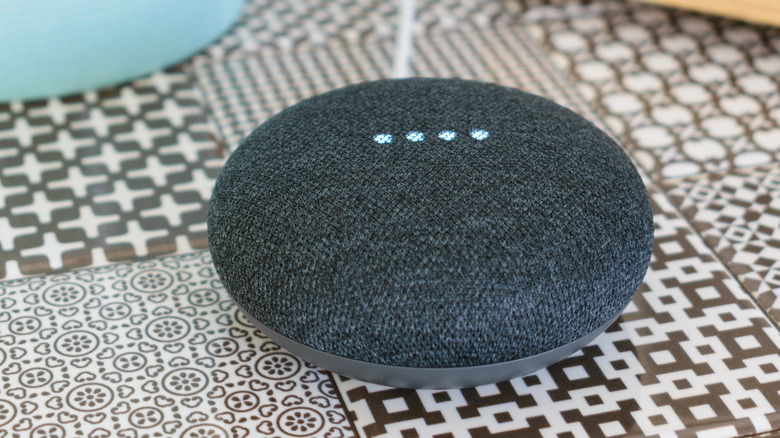 Google's Nest mini speaker on a table.
