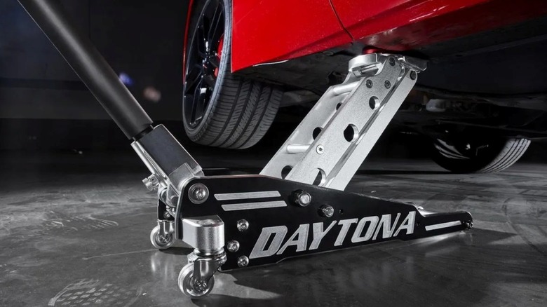 Using the Daytona 1.5-Ton Ultra Low-Profile Lightweight High-Performance Aluminum Racing Jack to lift a car.